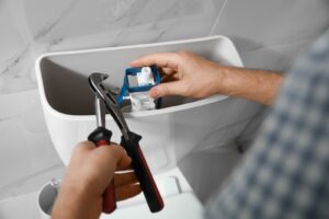 homeowner attempting to fix plumbing issue with constantly running toilet